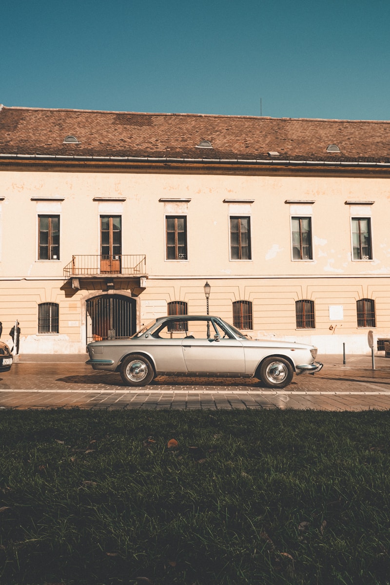 a white car parked in front of a building